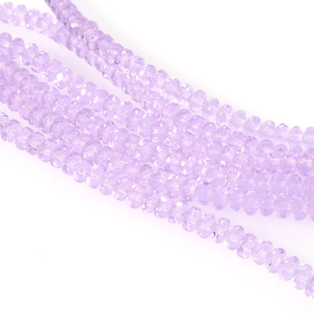 Fil de perles de verre violet pastel transparent facetté 2x3mm.