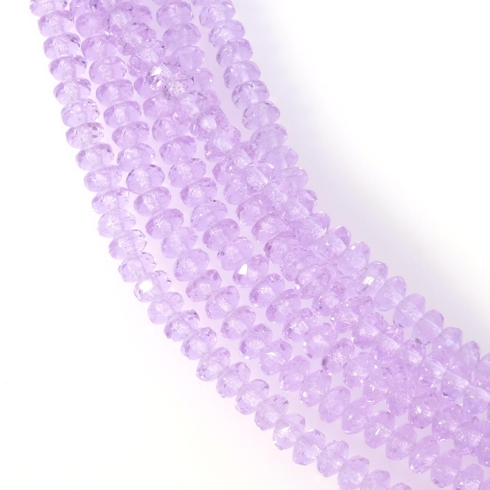 Fil de perles de verre violet pastel transparent facetté 2x3mm.