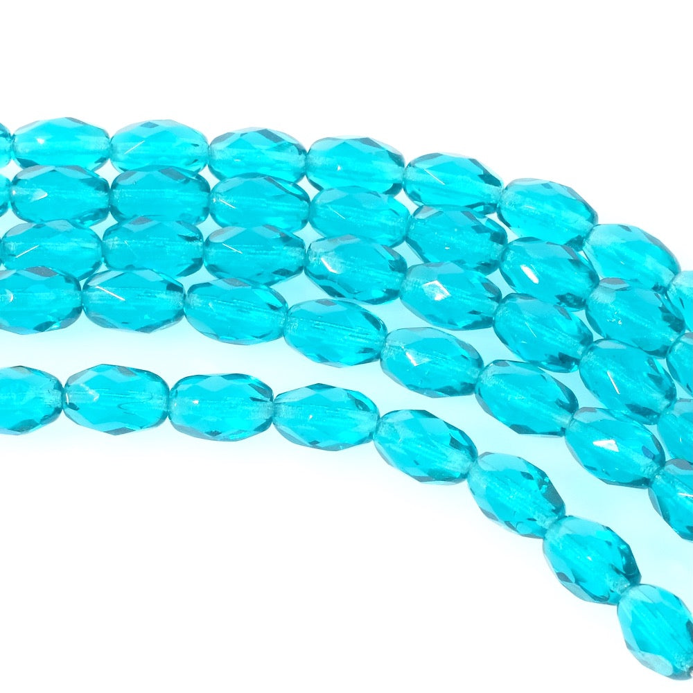 Fil de perles bleues paon transparentes en verre facetté de 9x6mm.