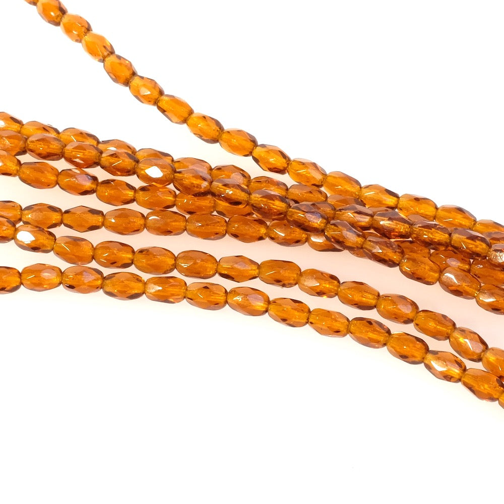 Fil de perles de Bohème olives facettées 6x4mm marron transparent.