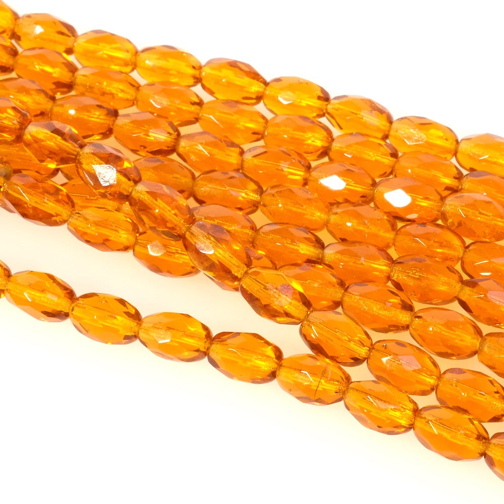 Fil de perles de Bohème olives facettées orange miel transparent.