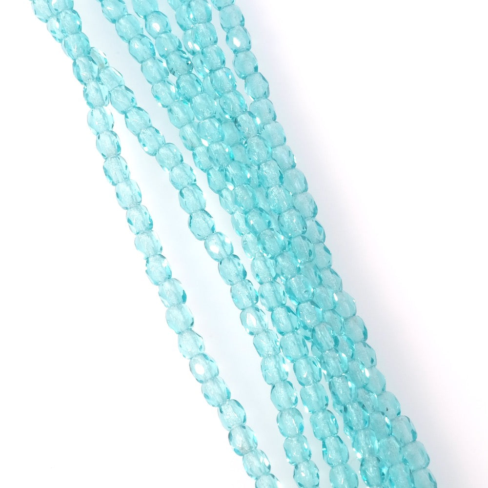 Fil de perles rondes facettées 3mm turquoise clair transparent.