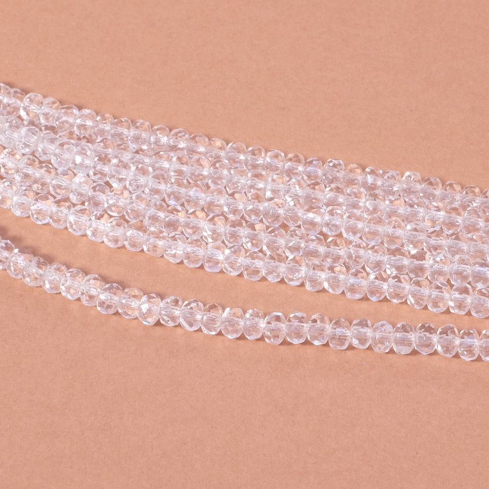 Fil de perles transparentes en verre donuts facetté 2x3mm.