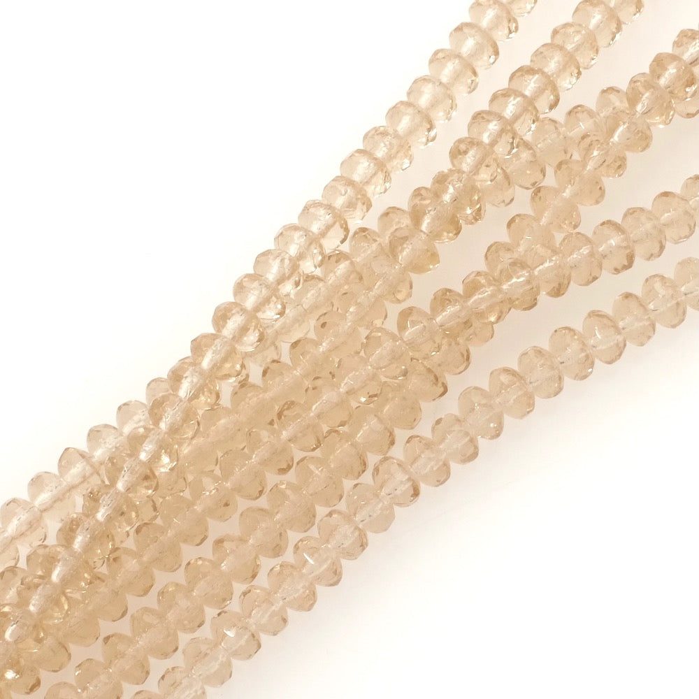 Fil de perles de Bohème donuts facetté beige transparent 3x5mm.