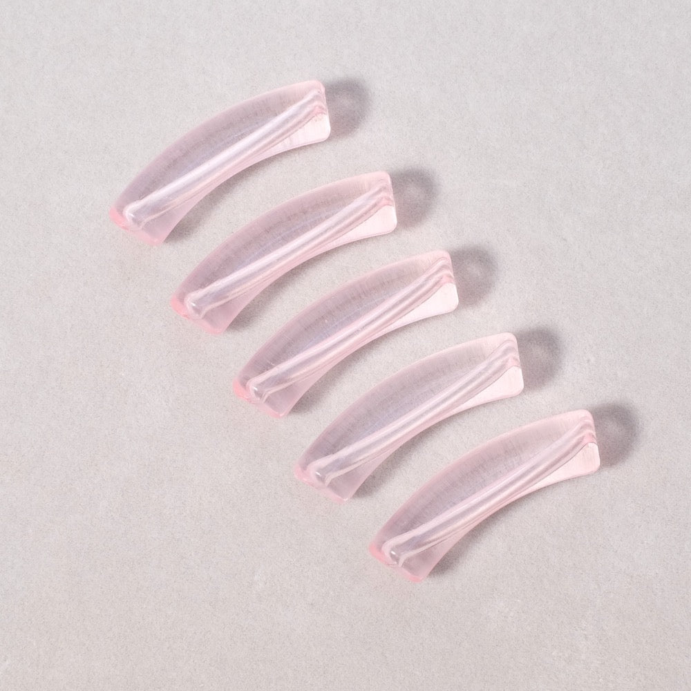 Perles tubes incurvées en acrylique rose transparent.