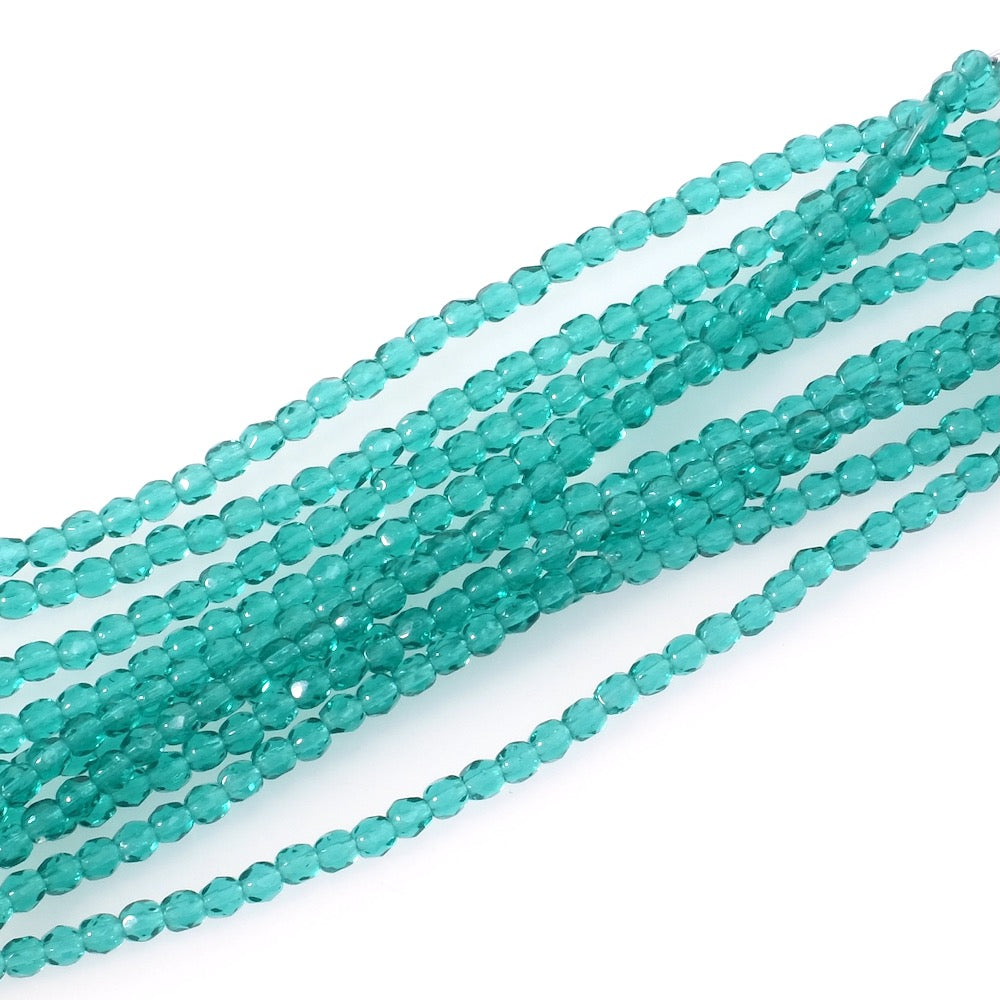 Fil de perles rondes facettées 3mm vert lagon transparent.