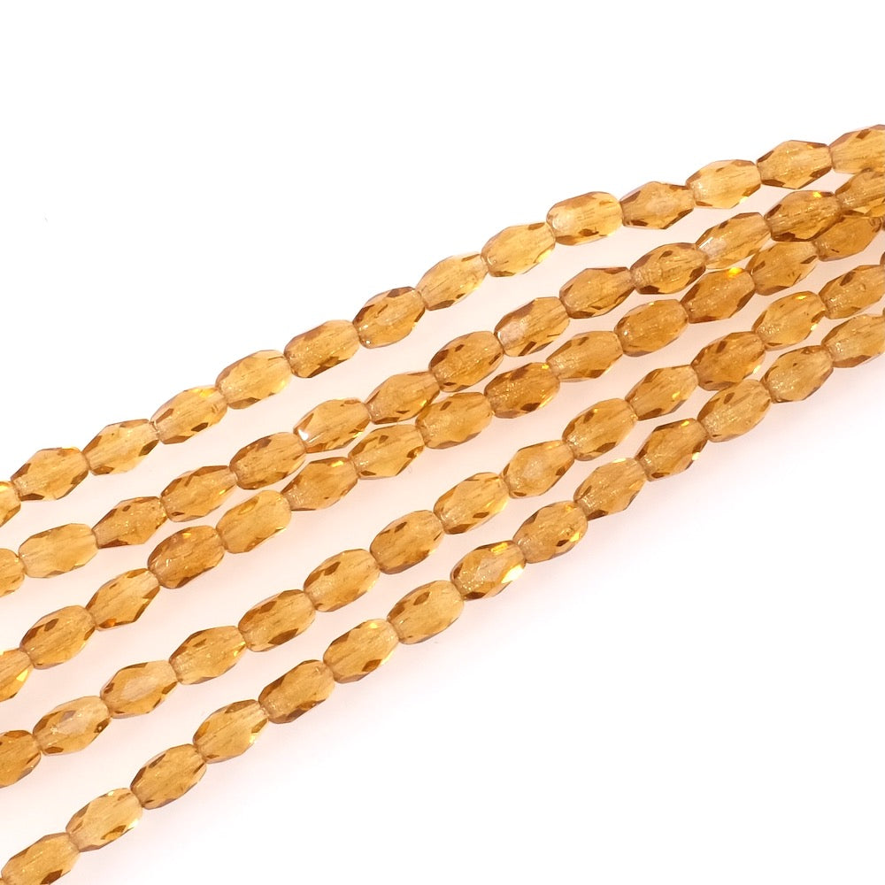 Fil de 21 perles de Bohème olives facettées 6x4mm jaune miel transparent.