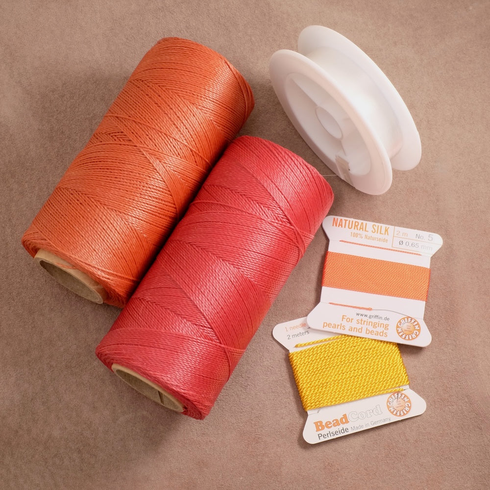 Jewellery threads and cords on beige suede