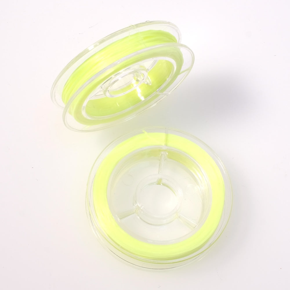 Bobine de fil élastique plat jaune fluo de 0,6 mm.