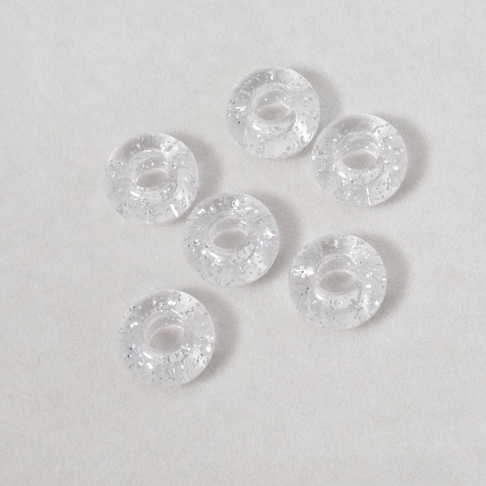 6 perles donuts transparentes en acrylique pailleté argenté de 14mm.