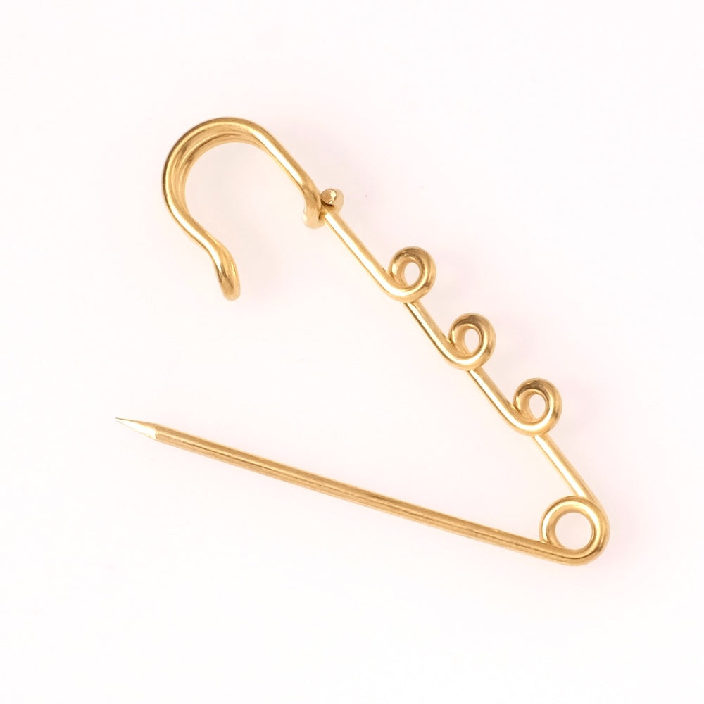 Broche épingle à nourrice dorée en acier inoxydable avec trois anneaux décoratifs.