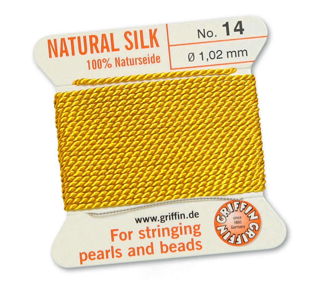Fil de soie naturelle jaune de 1,02 mm sur une bobine avec des informations sur le produit.