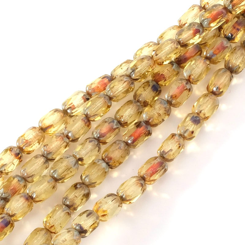 Fil de perles de Bohème olives facettées 6x4mm aux nuances orange.