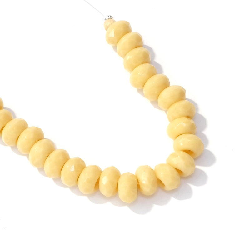 Fil de perles rondes facettées crème 9x5mm