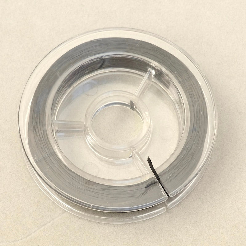 Bobine de fil élastique plat noir de 0,6 mm.