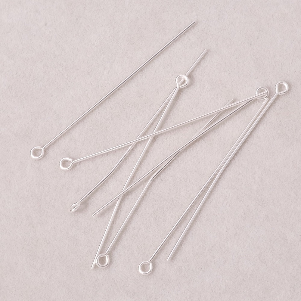 Dix clous à œil en laiton argenté de 45 mm.