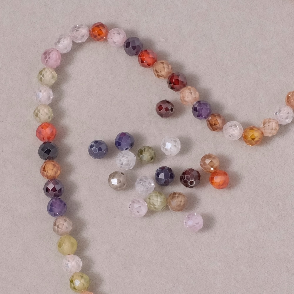 Fil de perles ronde facettée 4mm en Oxyde de Zirconium ou Zircone cubique multicolore