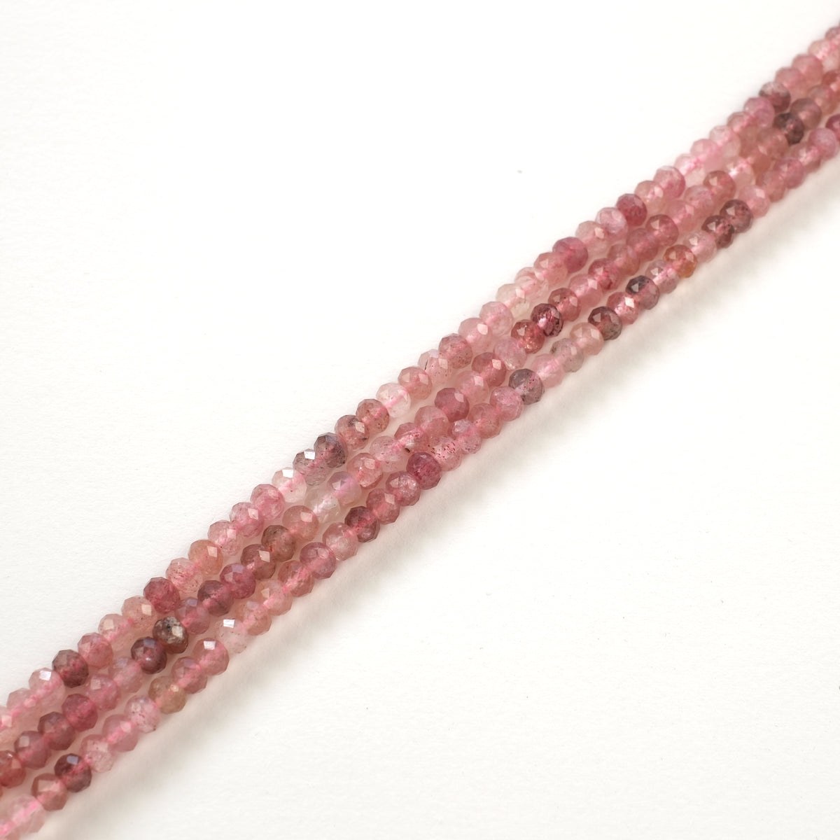 Close-up of the red inclusions in the strawberry quartz rondelles