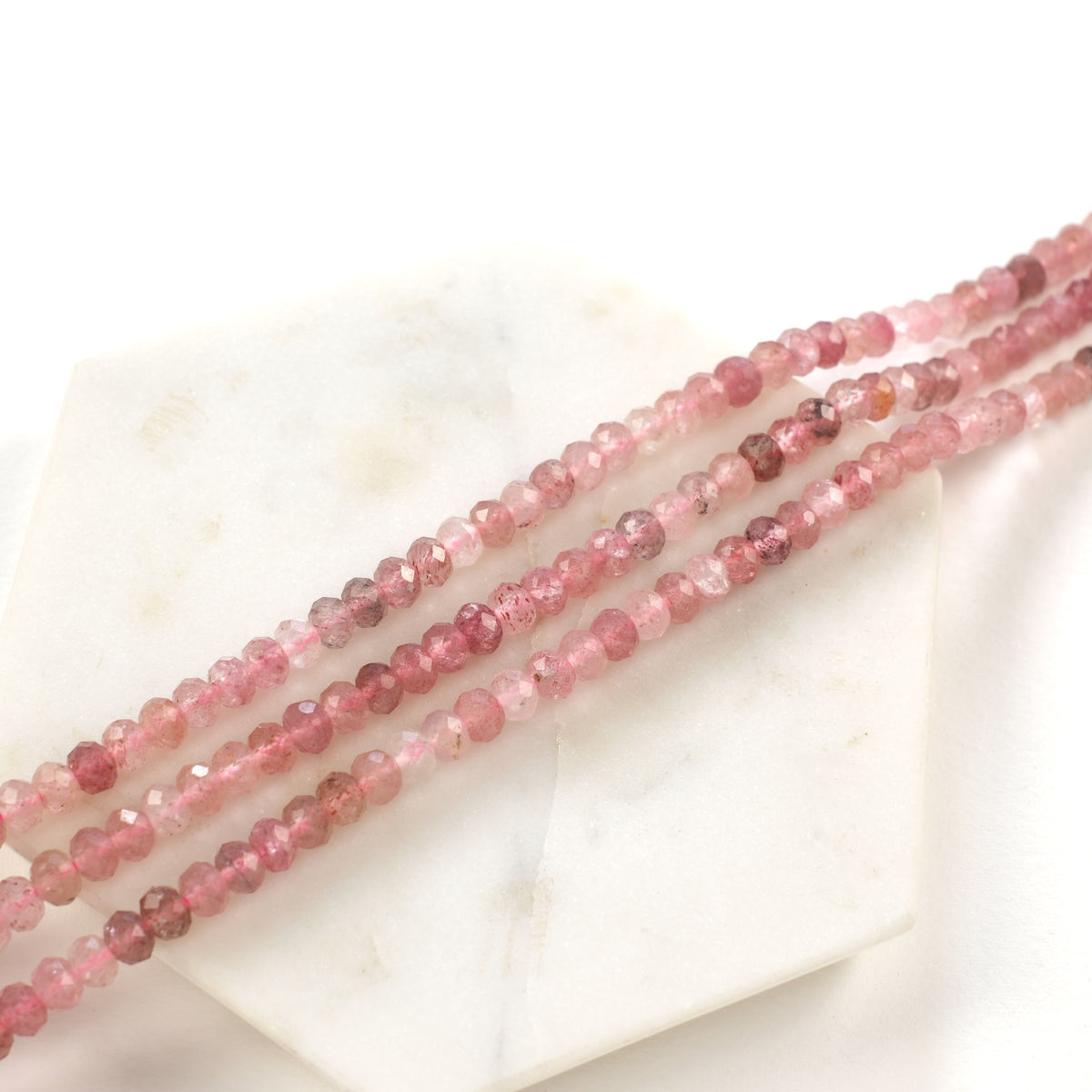 Strand of natural strawberry quartz with faceted rondelles