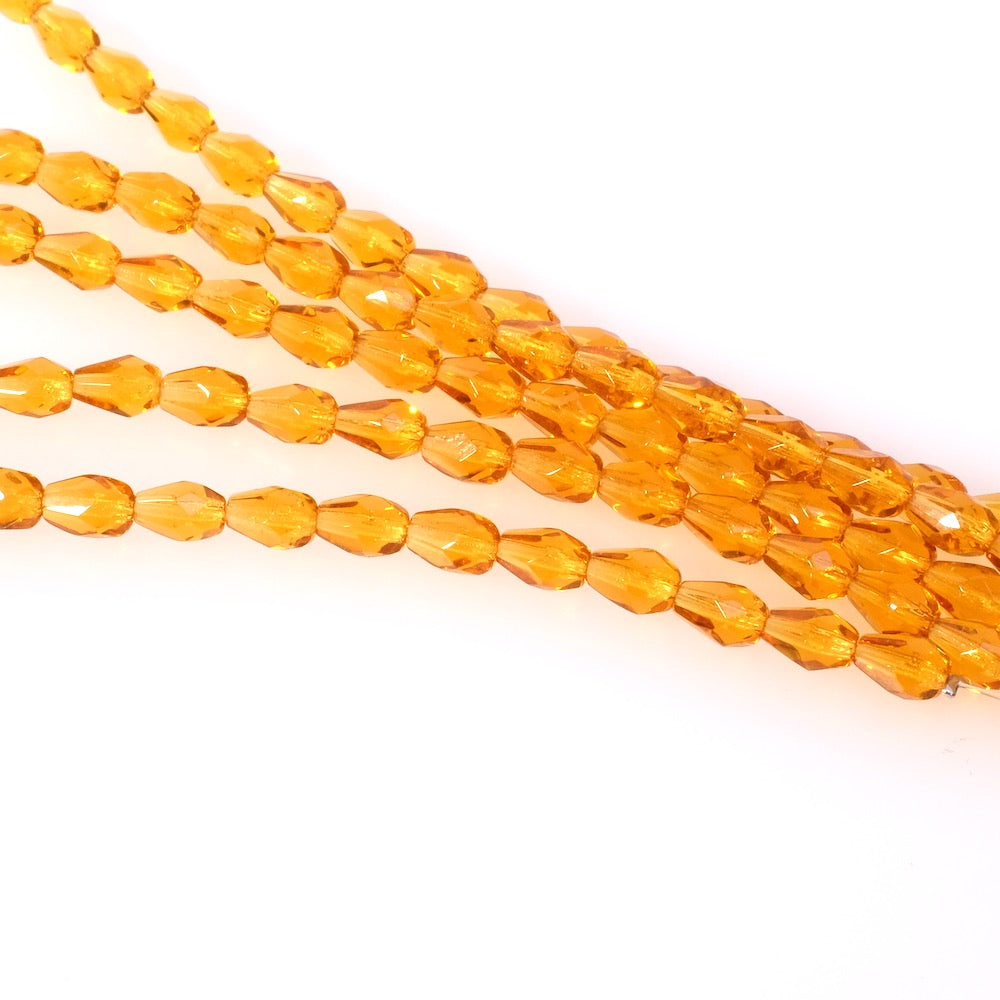 Fil de perles de Bohème gouttes 7x5mm orange miel transparent