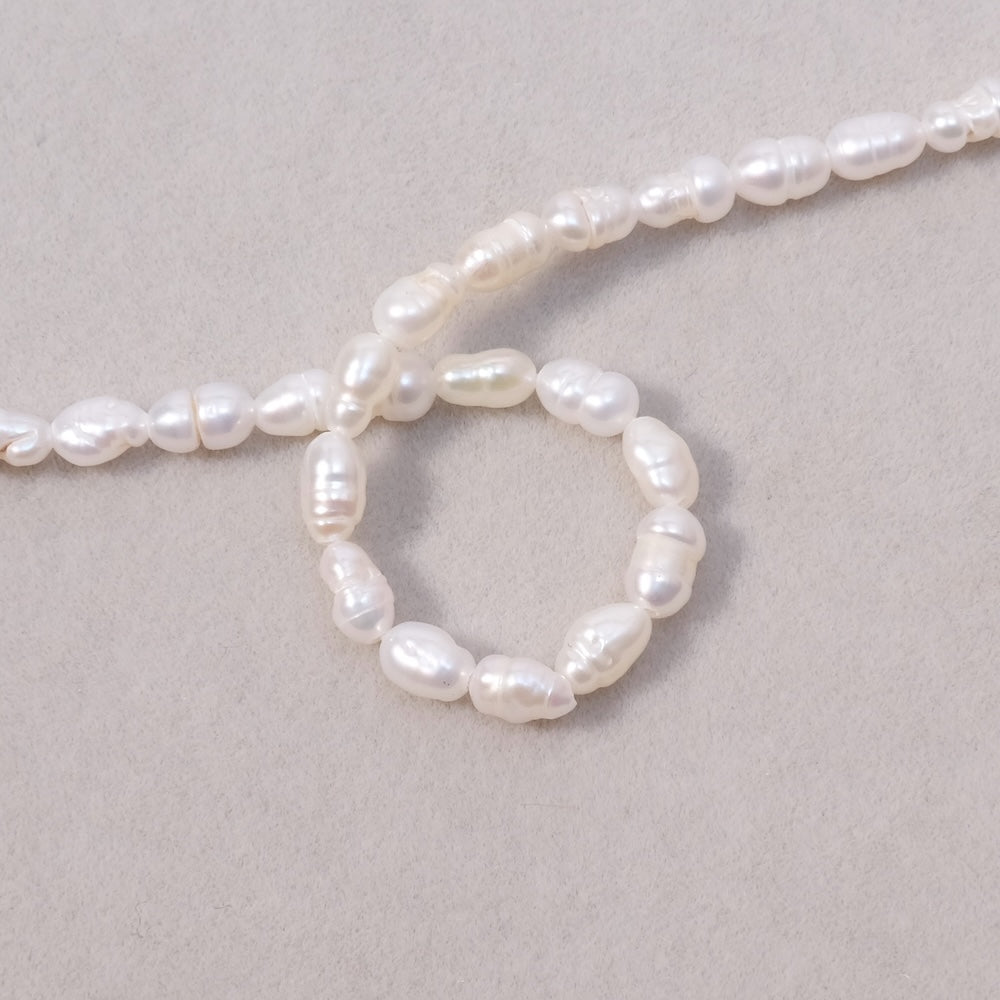 Fil de perles ovales 3x6mm irrégulières de Nacre naturelle
