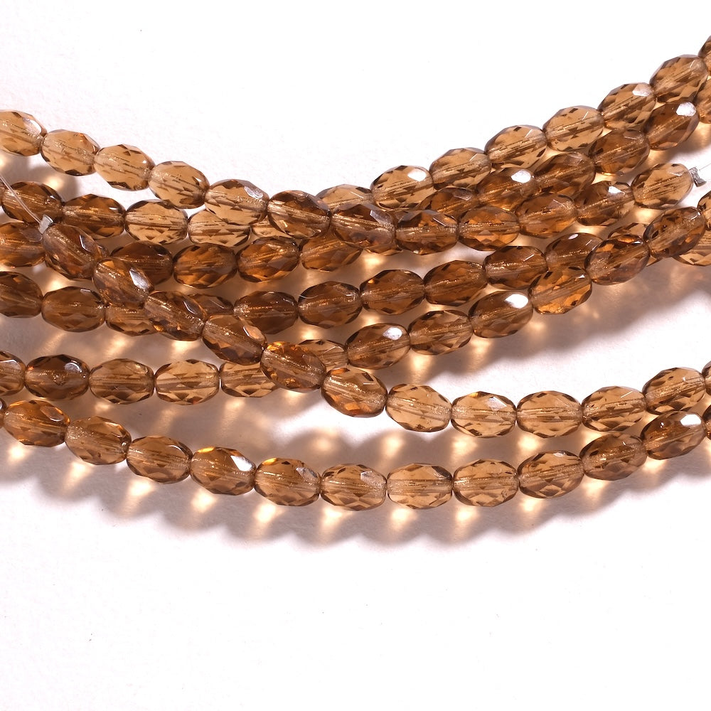 Fil de perles de Bohème ovales facettées 8 x 6 mm en verre brun doré transparent