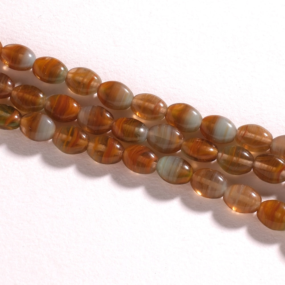 Fil de perles de Bohème ovales plates 9 x 7 mm en verre ambre marbré