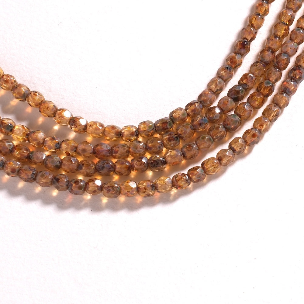 Fil de perles de Bohème rondes facettées 4 mm en verre topaze à finition Picasso