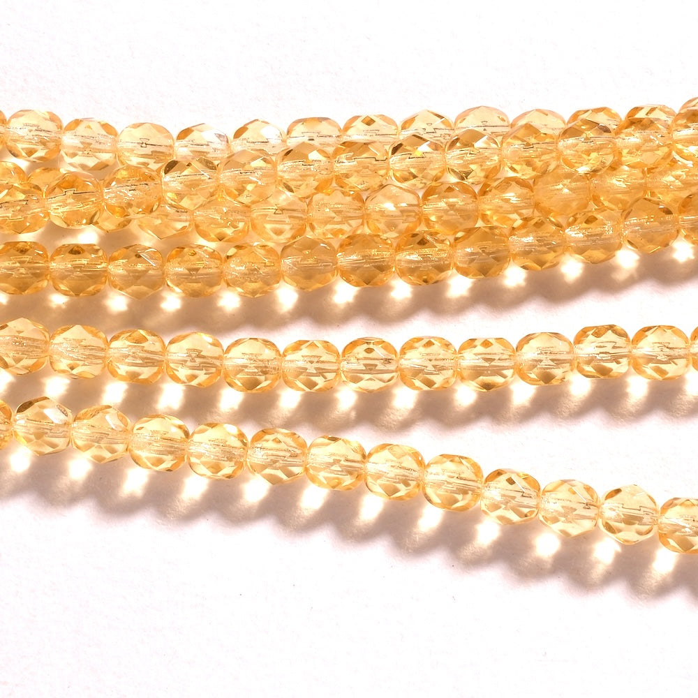 Fil de perles de Bohème rondes facettées 6 mm en verre jaune doré transparent