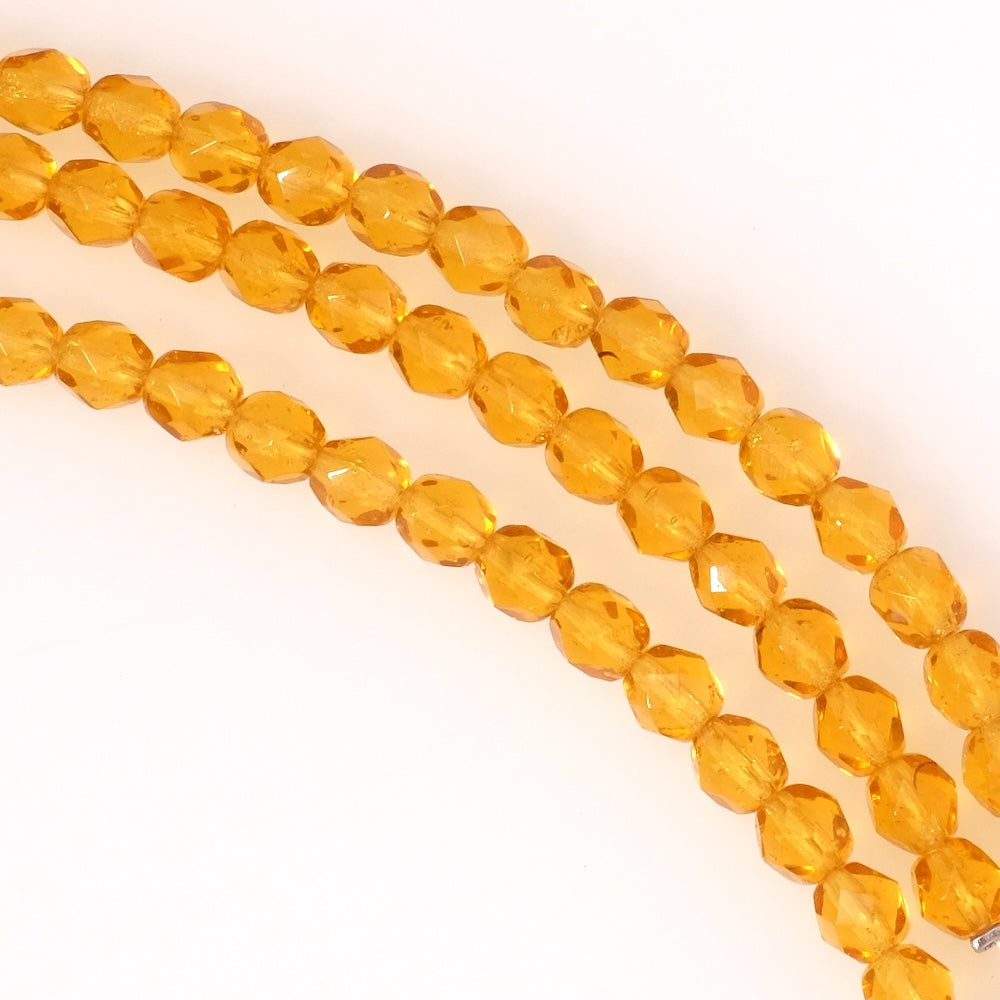 Fil de perles de Bohème rondes facettées 6mm orange miel transparent