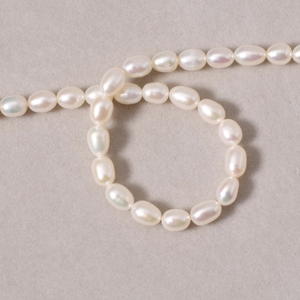 Fil de perles ovales irrégulières 5x7mm en Nacre naturelle blanche