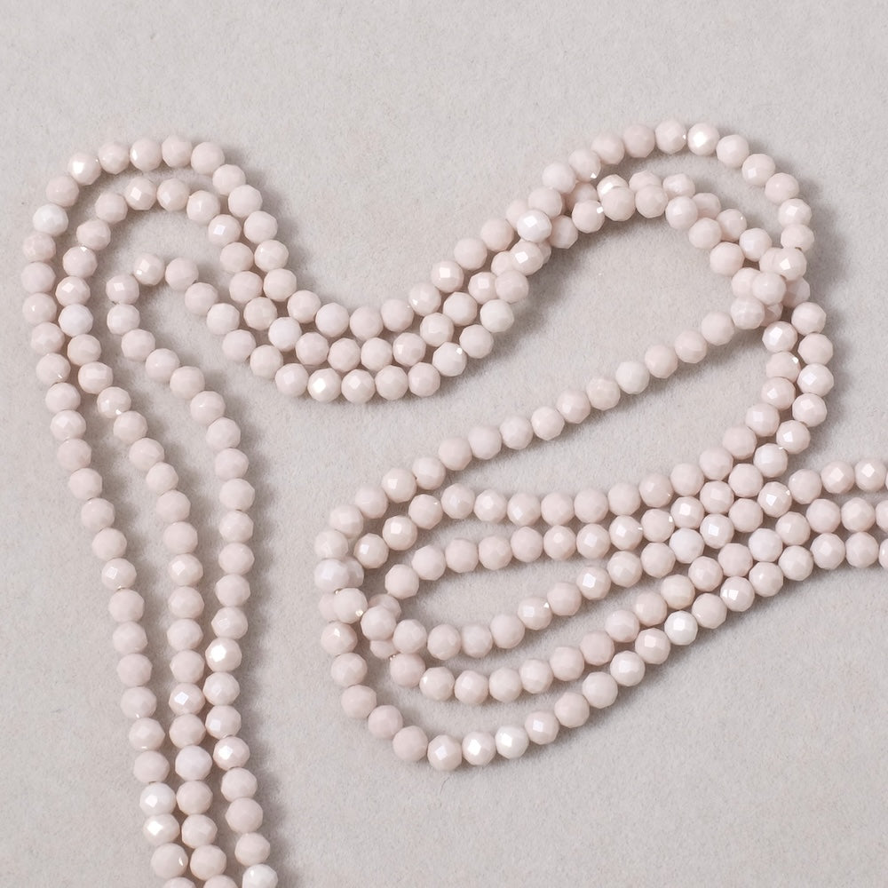 Fil de perles ronde facettée 3mm en Oxyde de Zirconium ou Zircone cubique beige