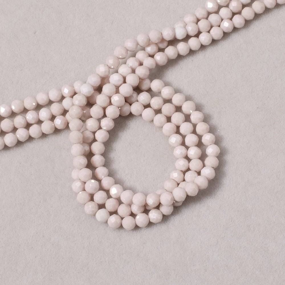 Fil de perles ronde facettée 3mm en Oxyde de Zirconium ou Zircone cubique beige