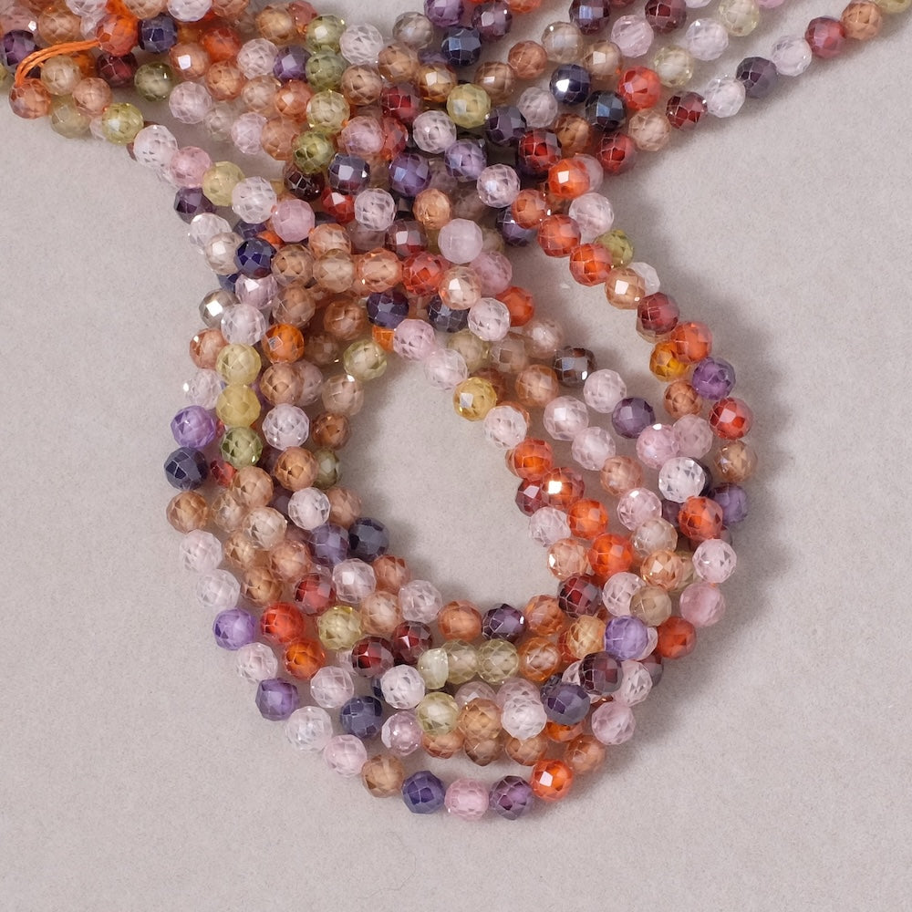 Fil de perles ronde facettée 4mm en Oxyde de Zirconium ou Zircone cubique multicolore