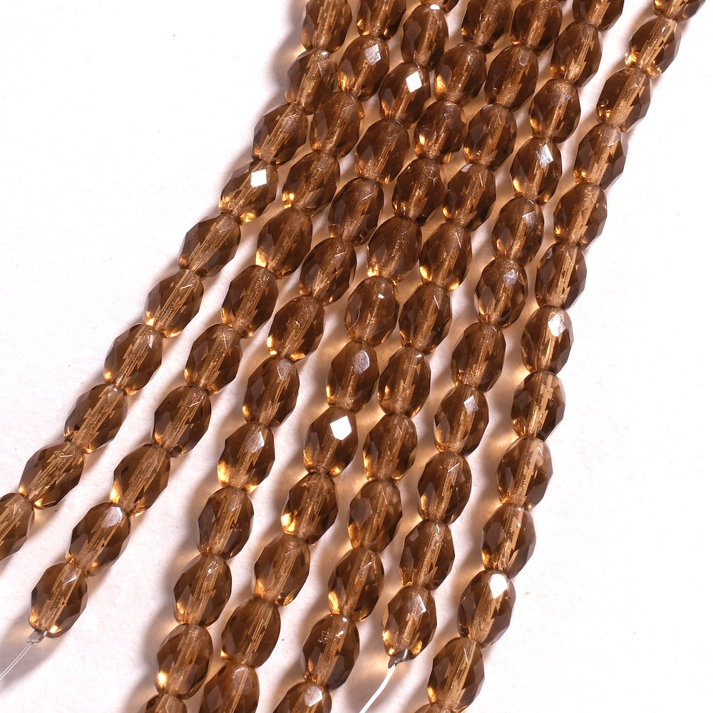 Rangs de perles ovales facettées brun doré 8 x 6 mm, reflets dorés sur les facettes