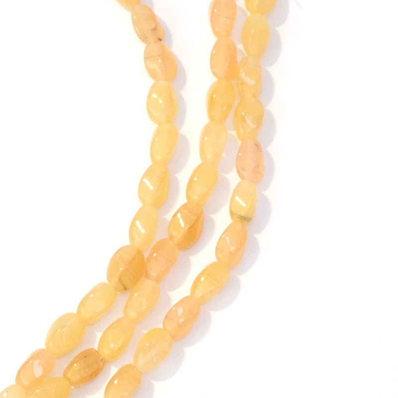 Fil de perles de Bohème ovales twistées 9x6mm jaune orangé transparent
