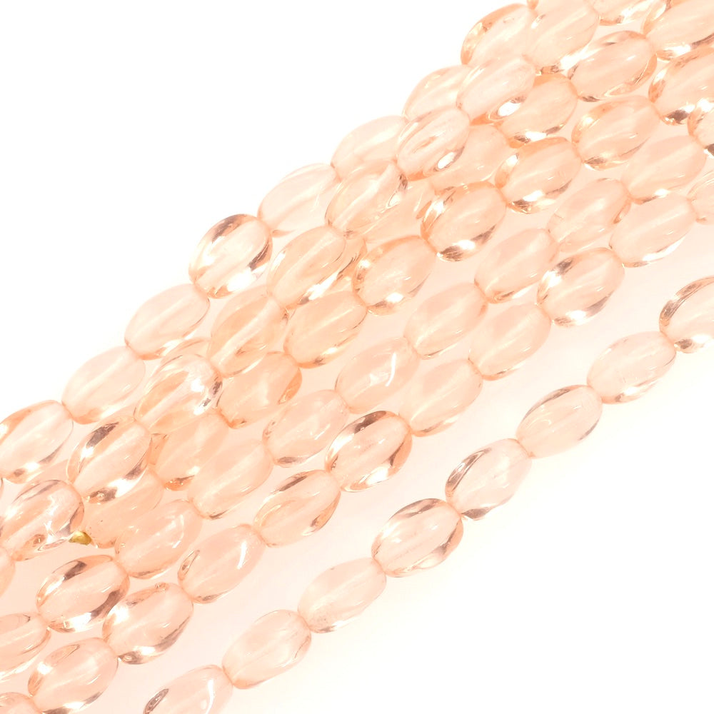 Fil de perles de Bohème ovales twistées 9x6mm rose pêche transparent