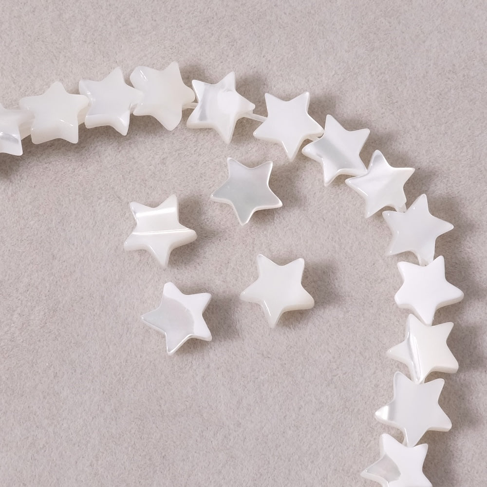 4 small white natural mother-of-pearl star beads