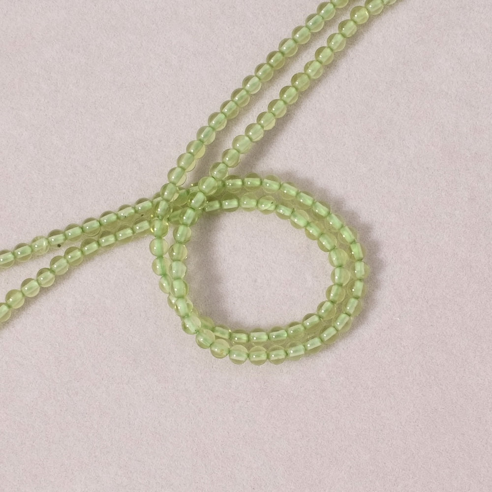 Strand of natural round 3mm beads in Peridot