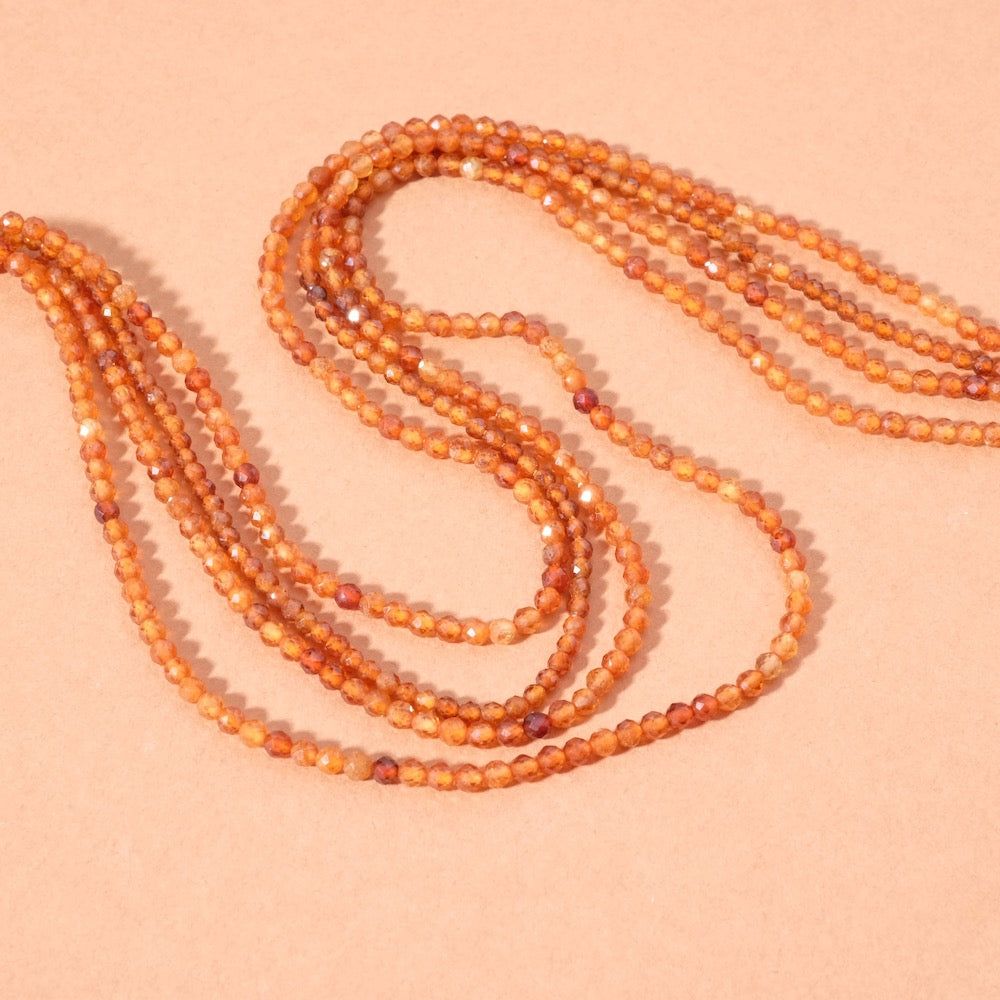 Strand of 2mm faceted garnet hessonite beads 