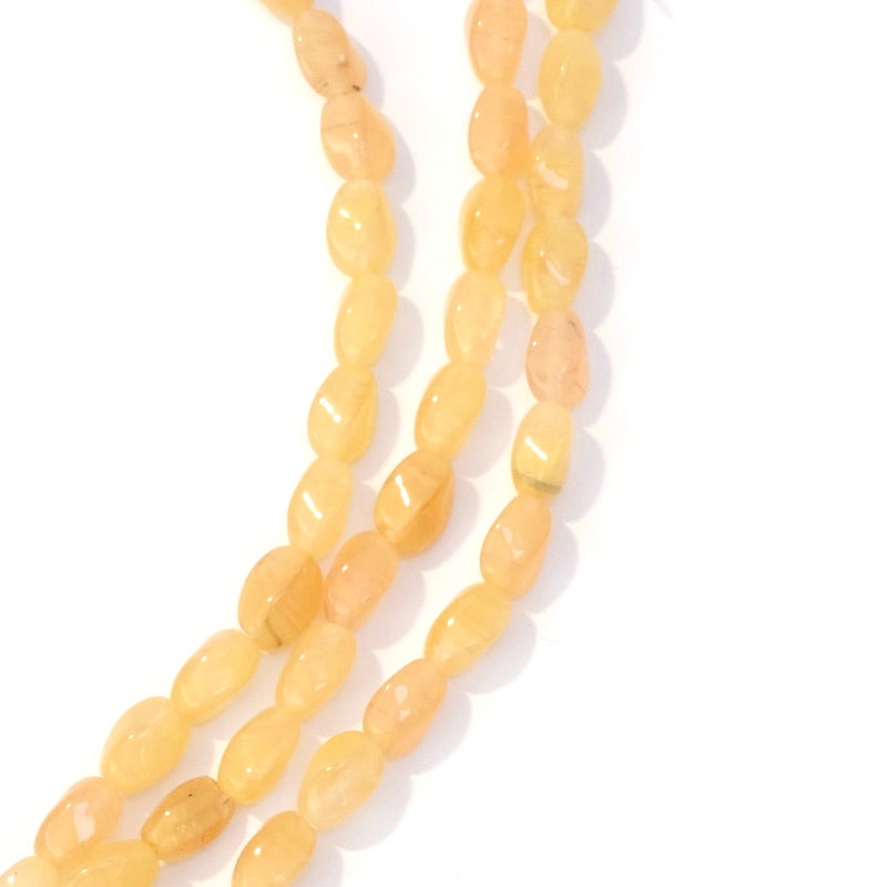 Strand of twisted oval Bohemian beads 9x6mm yellow-orange transparent